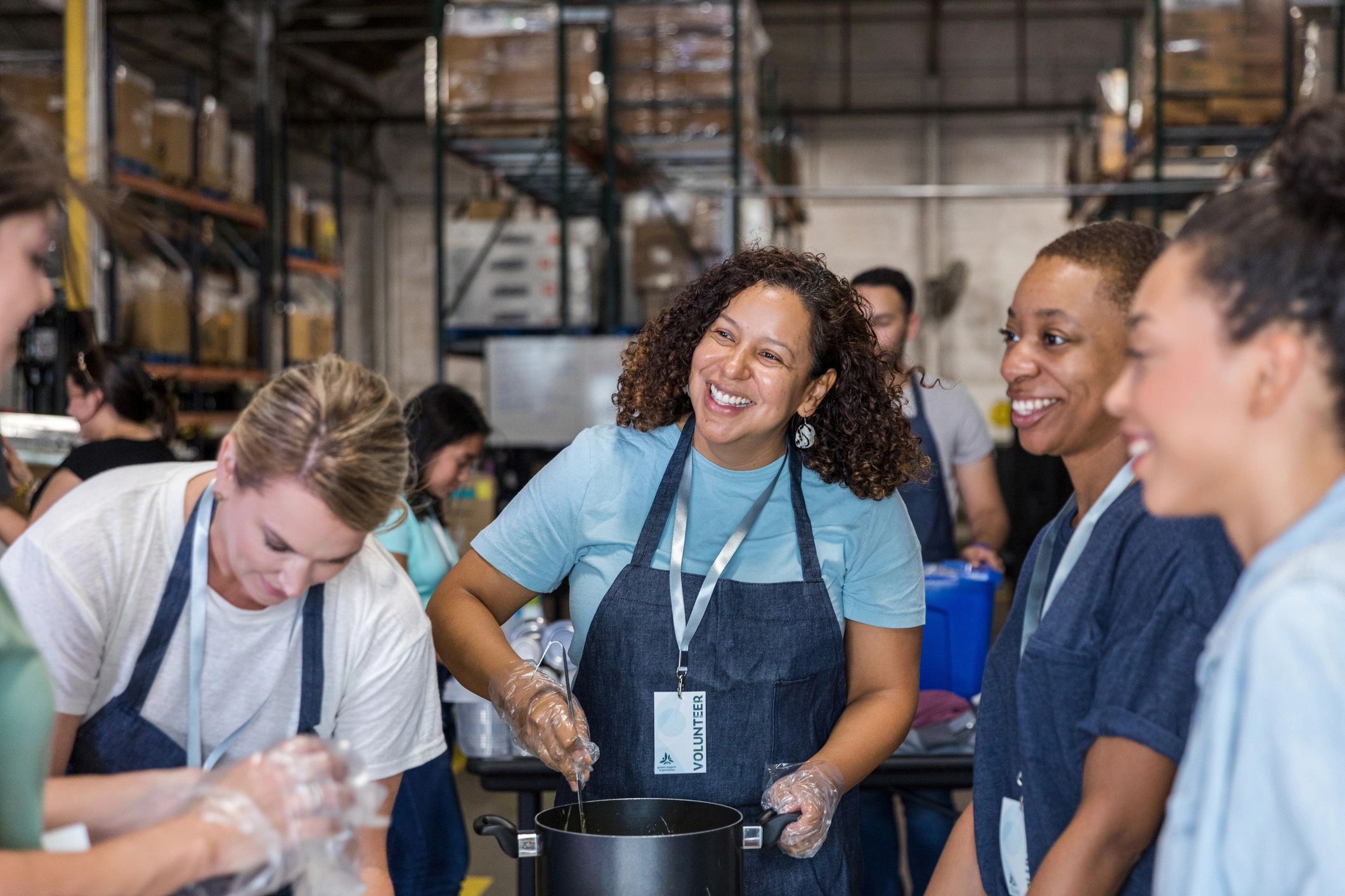 Women preparing food together for community support efforts