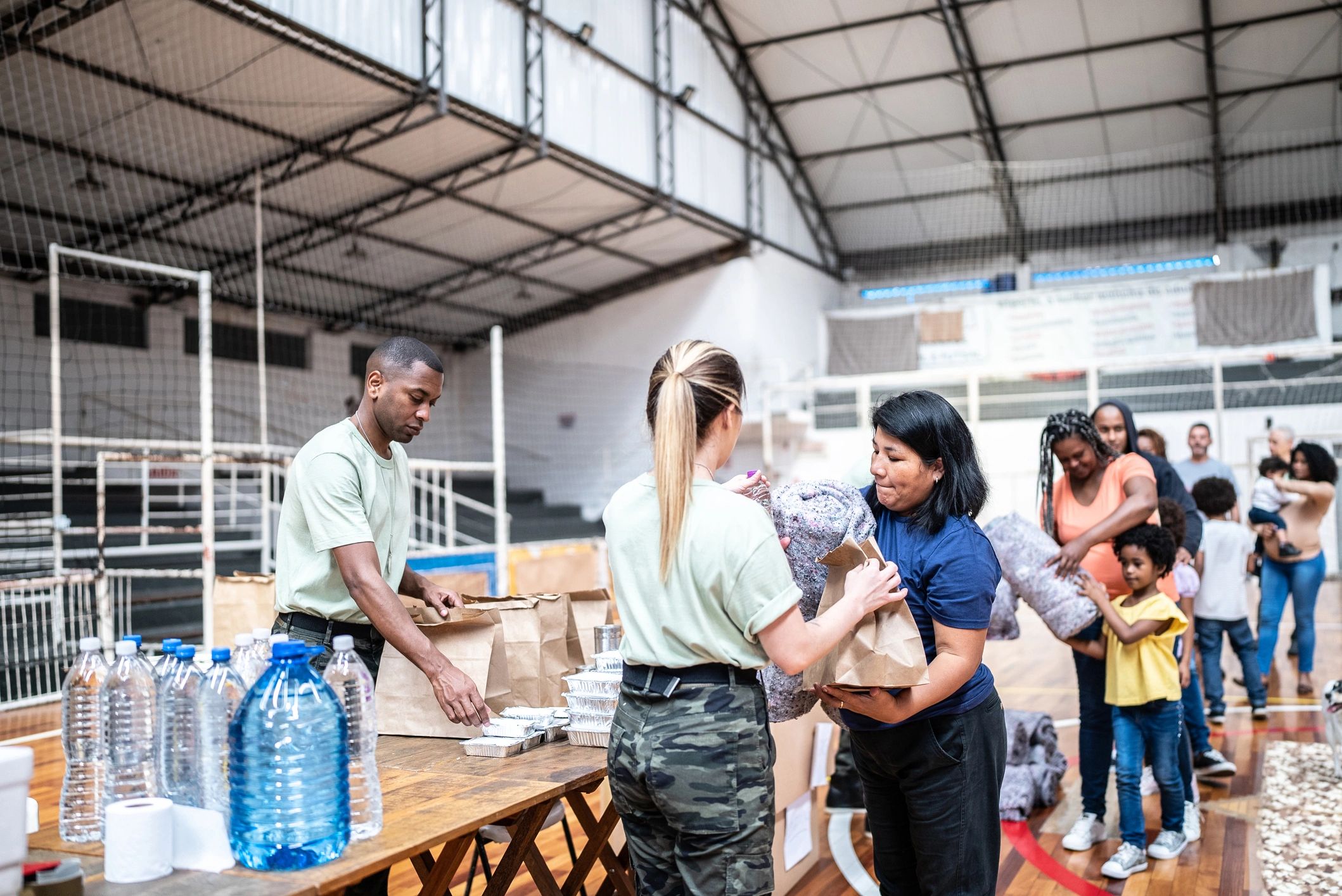 Volunteers assisting families with donated supplies