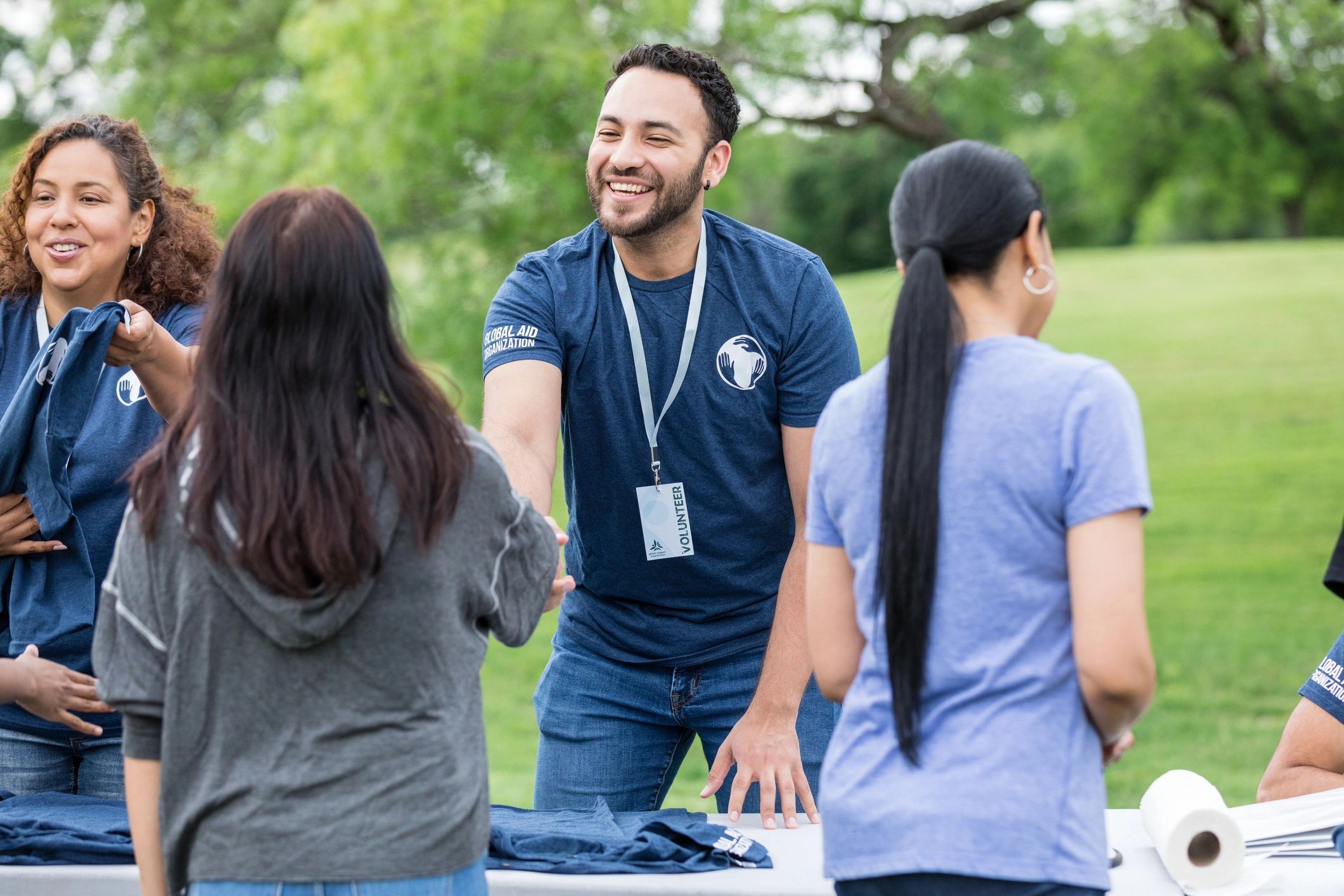 Volunteer greeting a community member outdoors