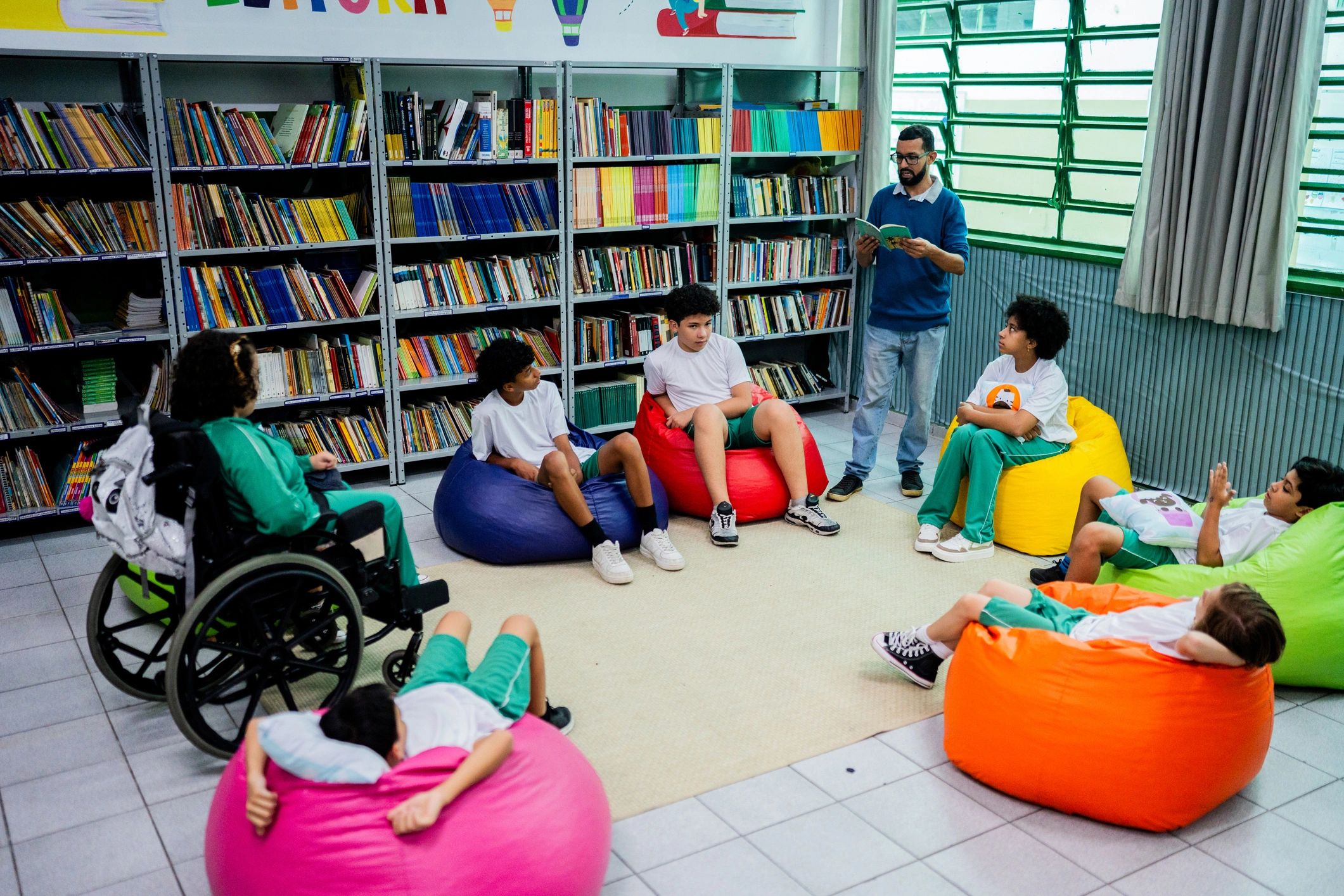 Teacher reading with children in a library setting